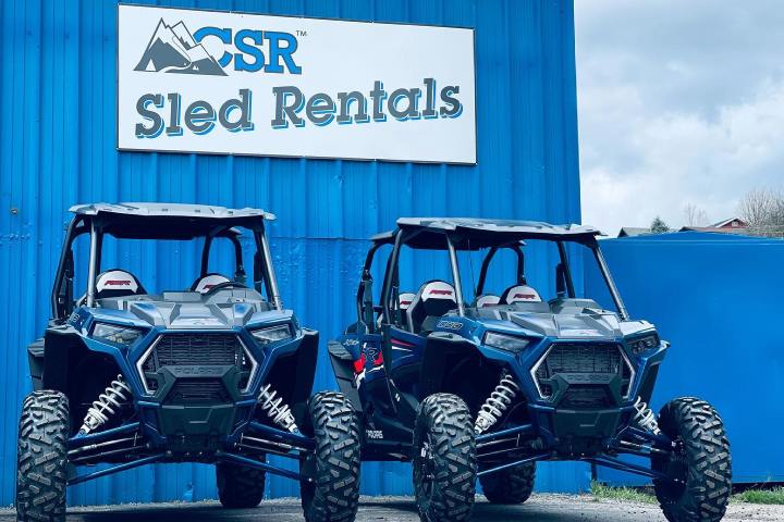 a blue truck parked in front of a building