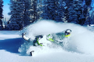 a man riding skis down a snow covered slope