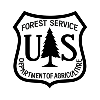 US Forest Service emblem with tree and text inside shield shape.