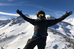 a man standing on top of a snow covered slope