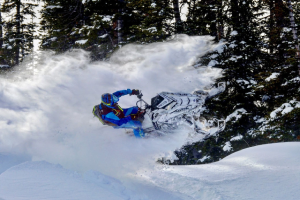 a man riding skis down a snow covered slope