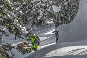 a man riding a snowboard down a snow covered slope