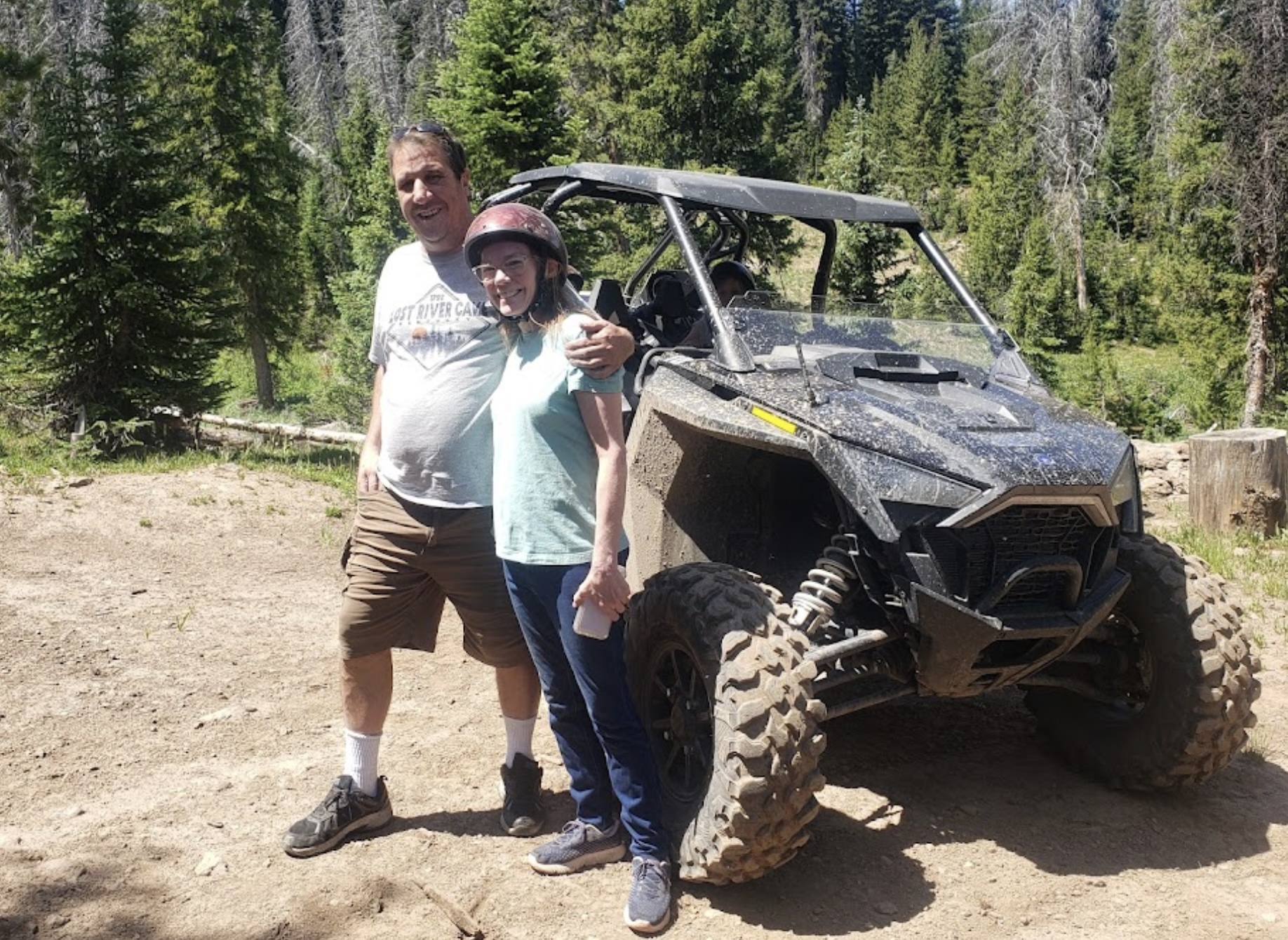 Couple riding in an RZR during a summer adventure in Colorado