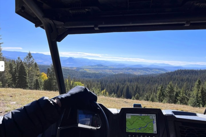 a RZR with a mountain in the background