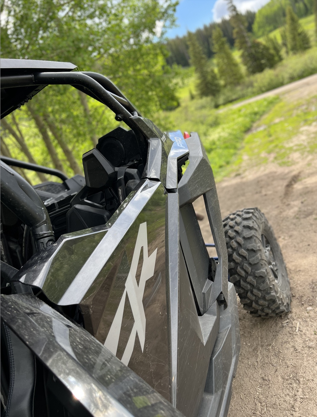 Side view of a Polaris RZR in Colorado mountain terrain