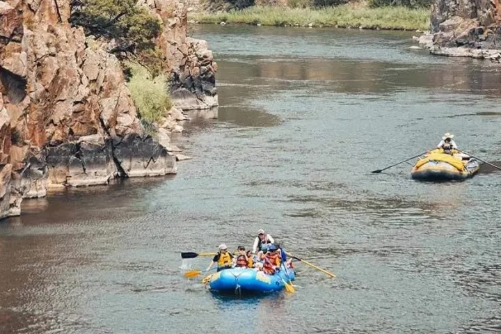 a group of people on a raft in a body of water