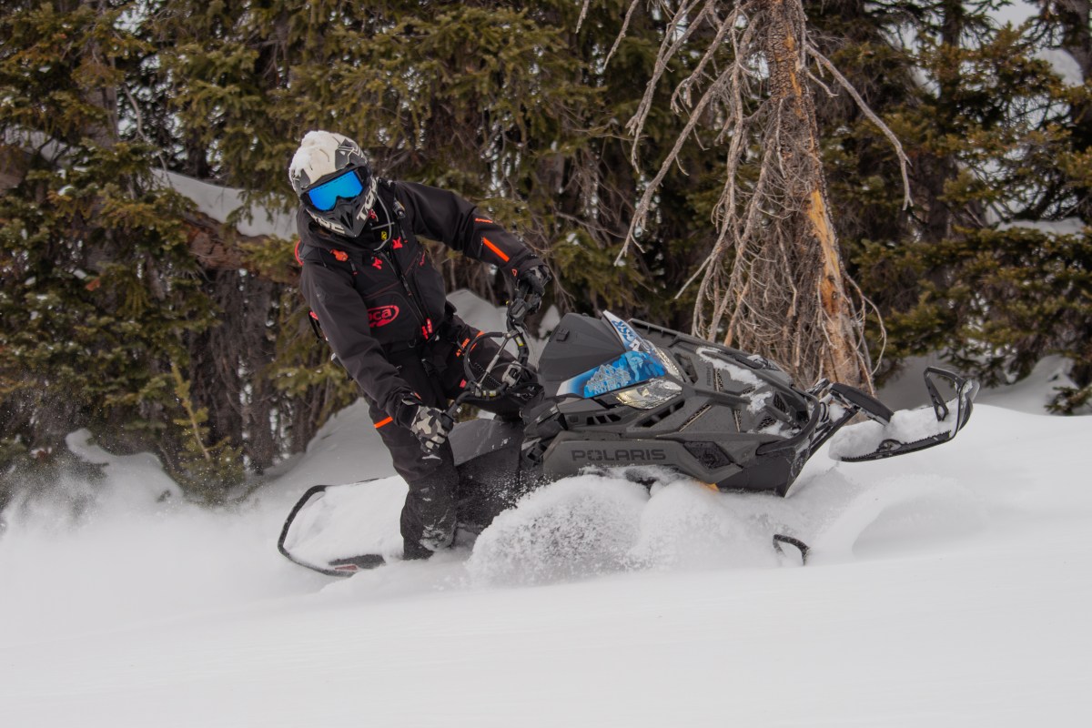 Snowmobiler riding deep powder in the Steamboat backcountry